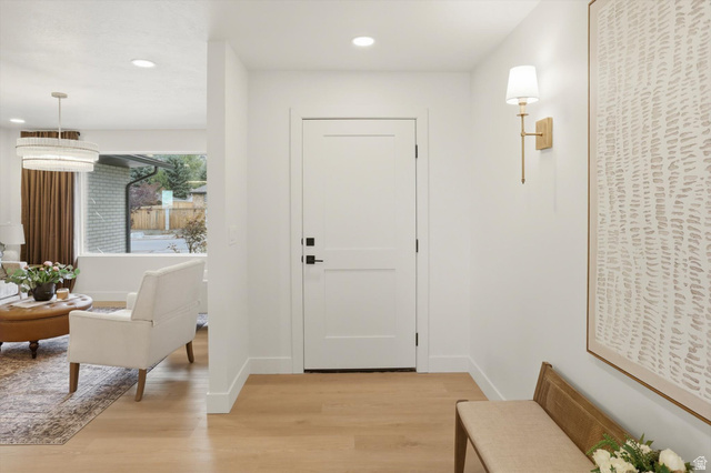 8760 Rustler Road Cottonwood Heights, UT 84093 - Photo 5 of 57 Entryway featuring light wood-finish flooring, recessed lighting, and a contemporary front door with matte black hardware