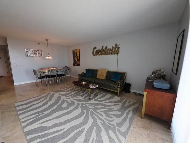 a living room with furniture and a dining table