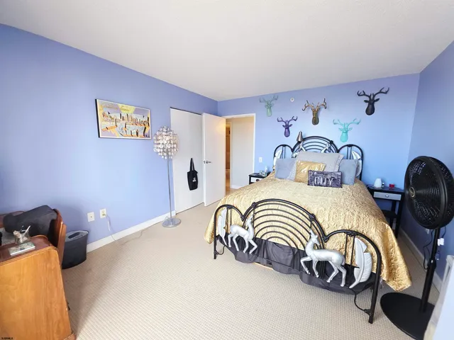 a bedroom with a bed and dresser