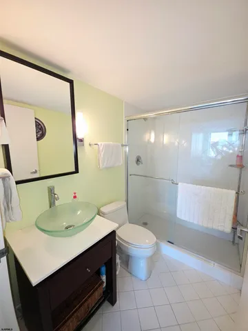 a bathroom with a sink toilet a mirror and shower