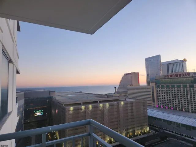 a view of roof deck with two chairs and a lamp on the wall