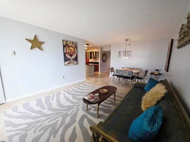 a living room with furniture and a dining table