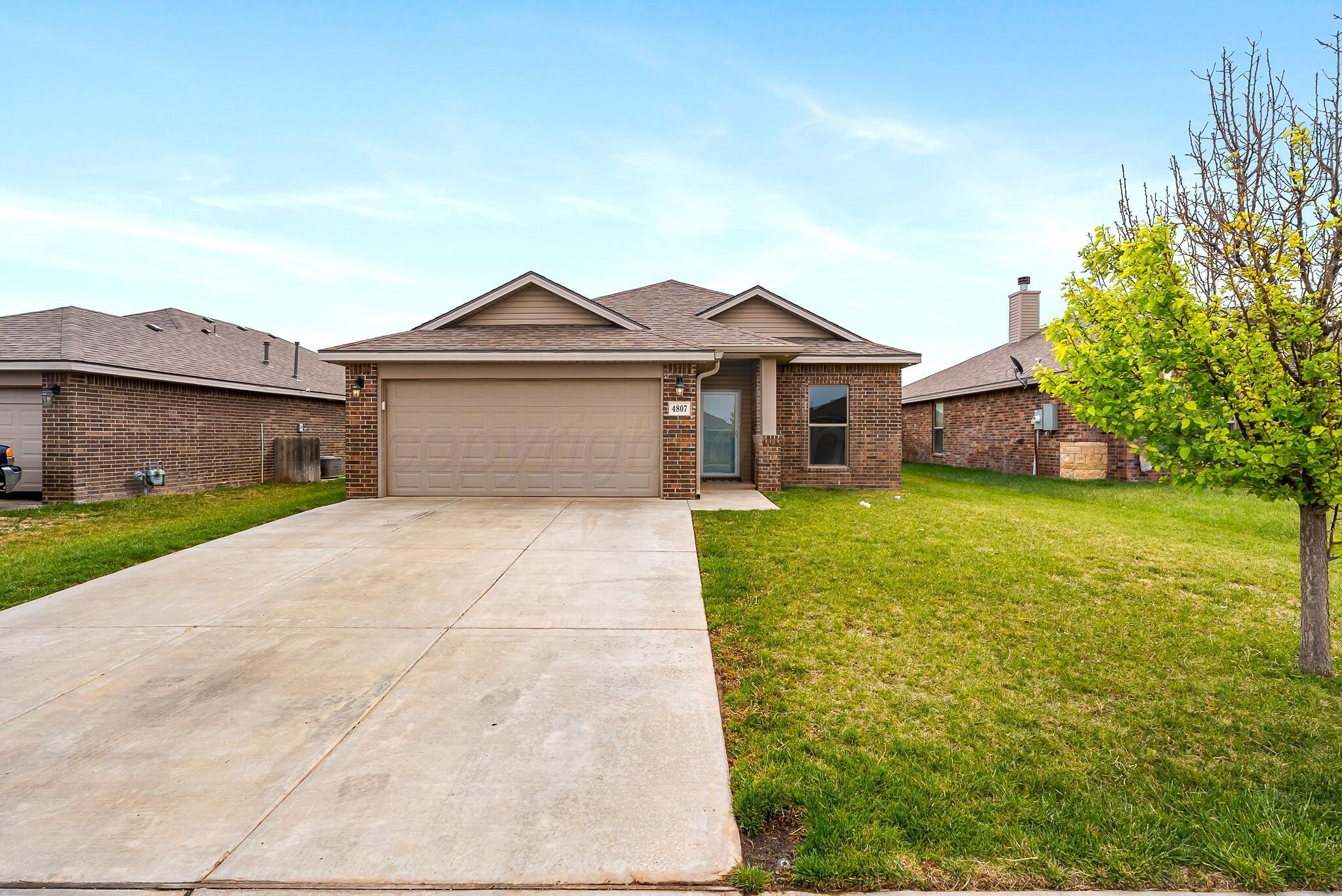 4807 Eberly Street Amarillo, TX 79118 - Photo 1 of 25 a front view of a house with garden