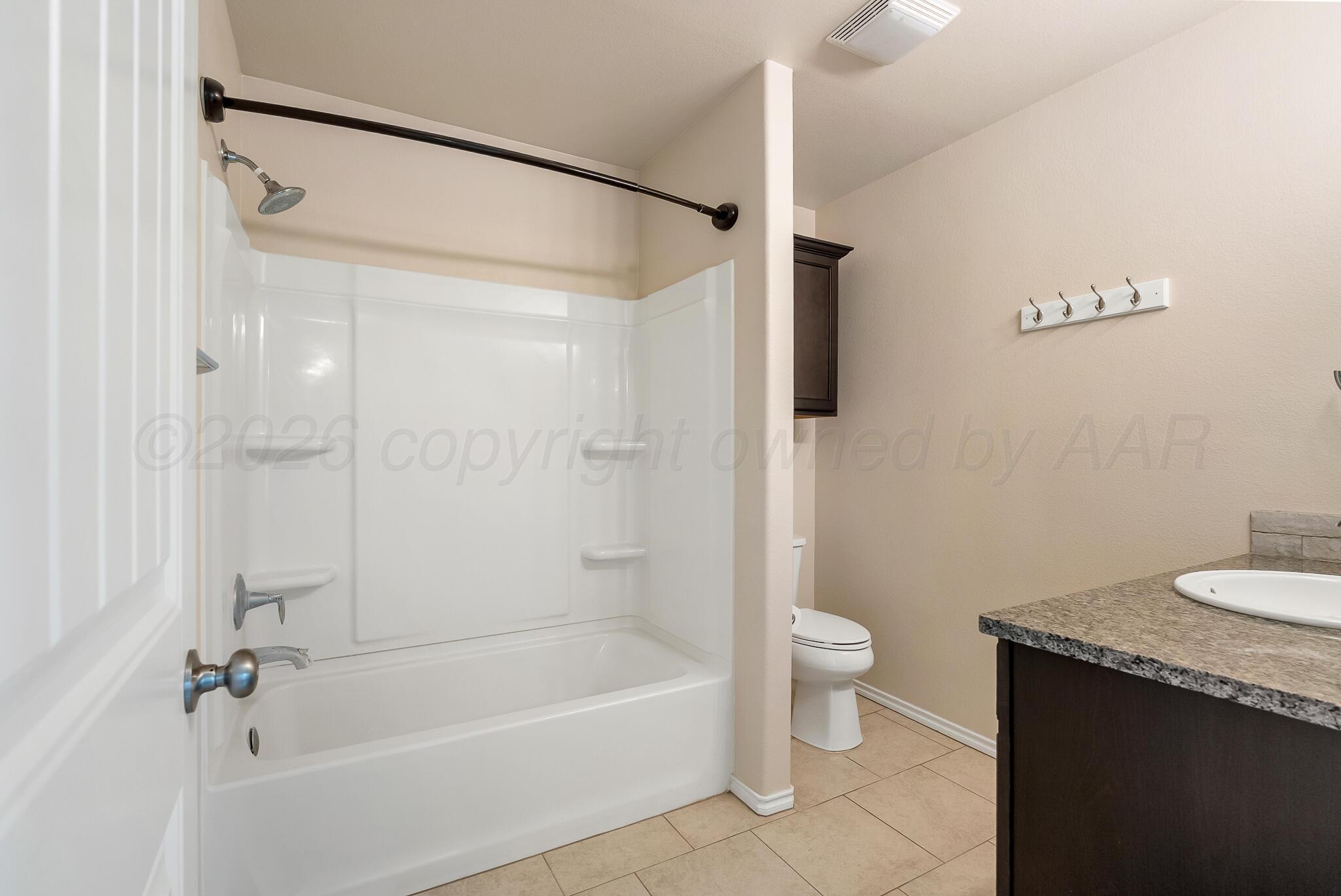 4807 Eberly Street Amarillo, TX 79118 - Photo 20 of 25 a bathroom with a granite countertop bathtub shower sink vanity and toilet