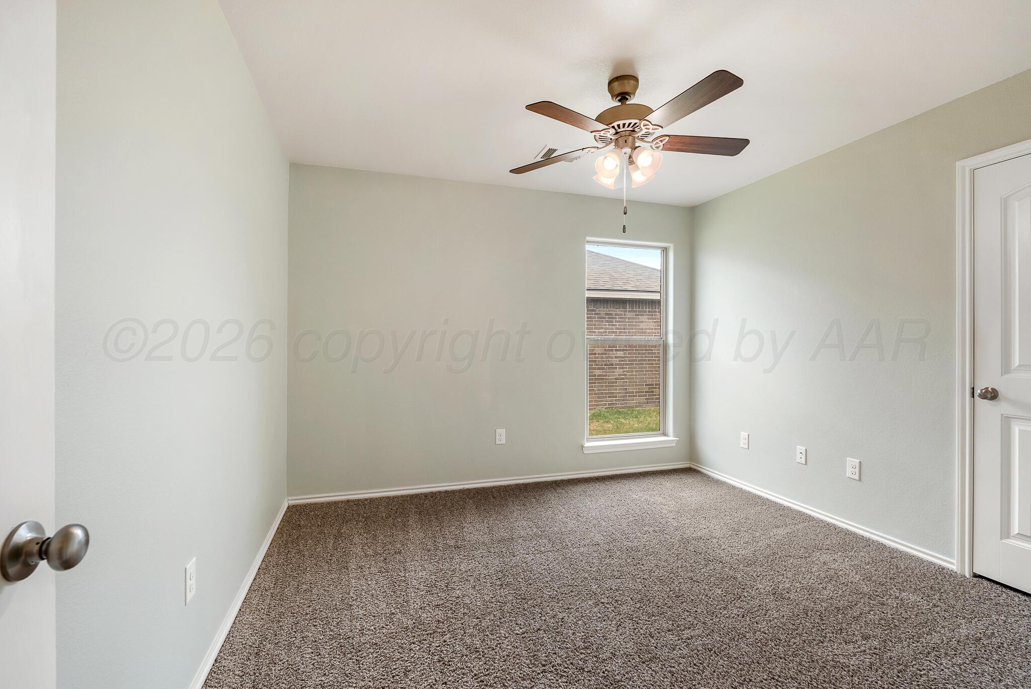 4807 Eberly Street Amarillo, TX 79118 - Photo 22 of 25 a view of a livingroom with a ceiling fan and wooden floor