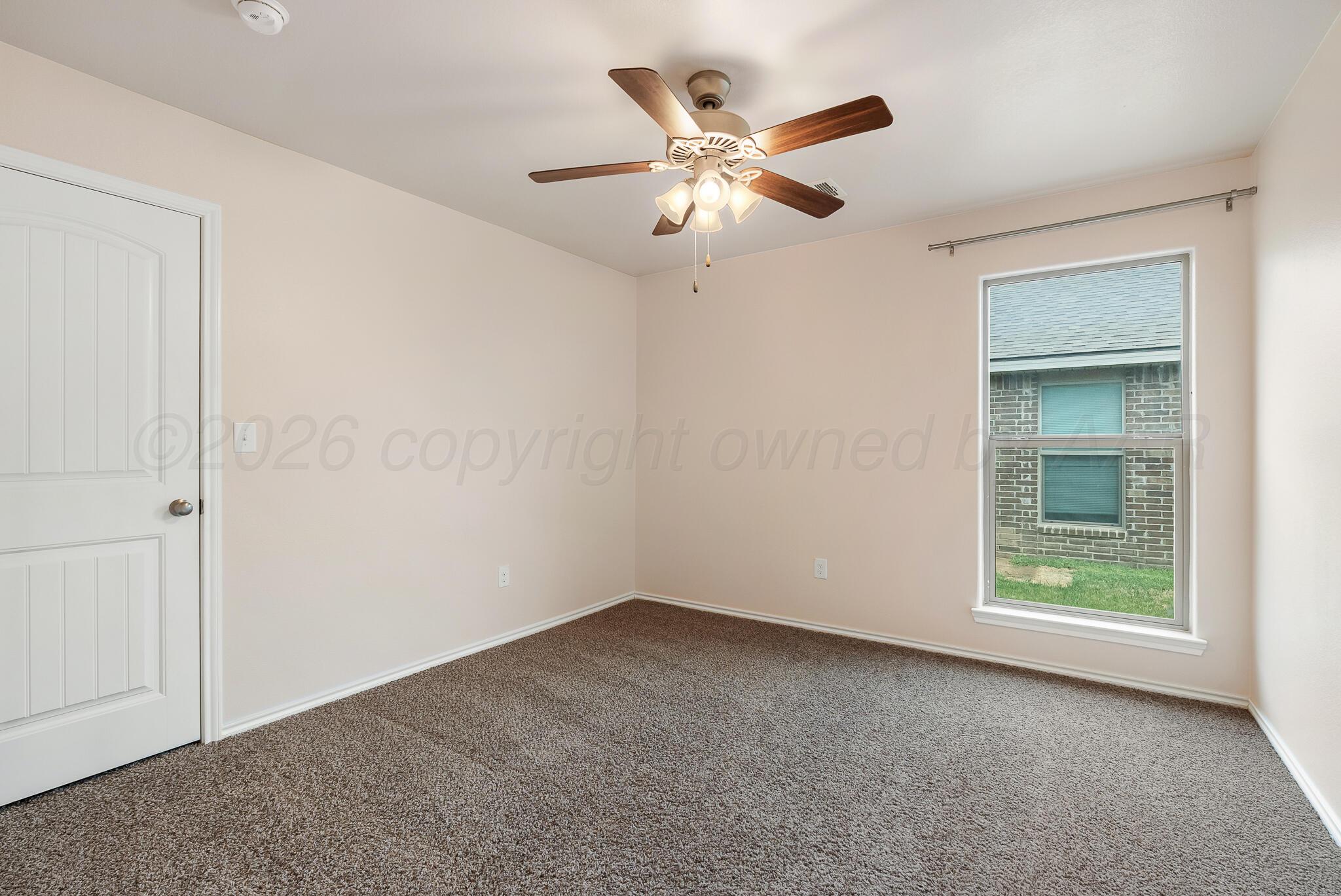 4807 Eberly Street Amarillo, TX 79118 - Photo 24 of 25 an empty room with windows and fan
