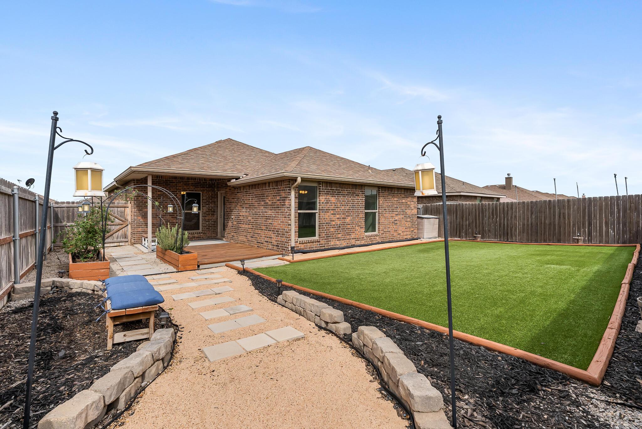4807 Eberly Street Amarillo, TX 79118 - Photo 4 of 25 a front view of a house with garden