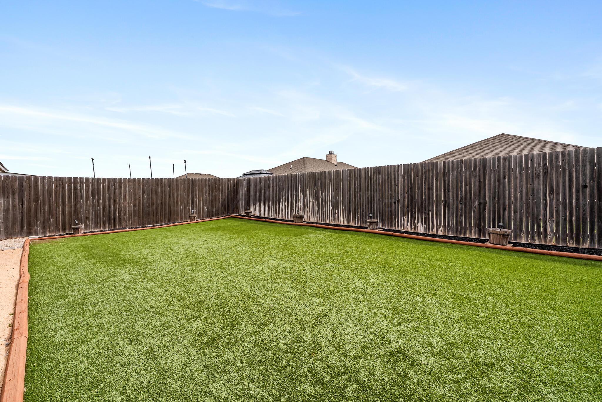 4807 Eberly Street Amarillo, TX 79118 - Photo 6 of 25 a view of a backyard with wooden fence