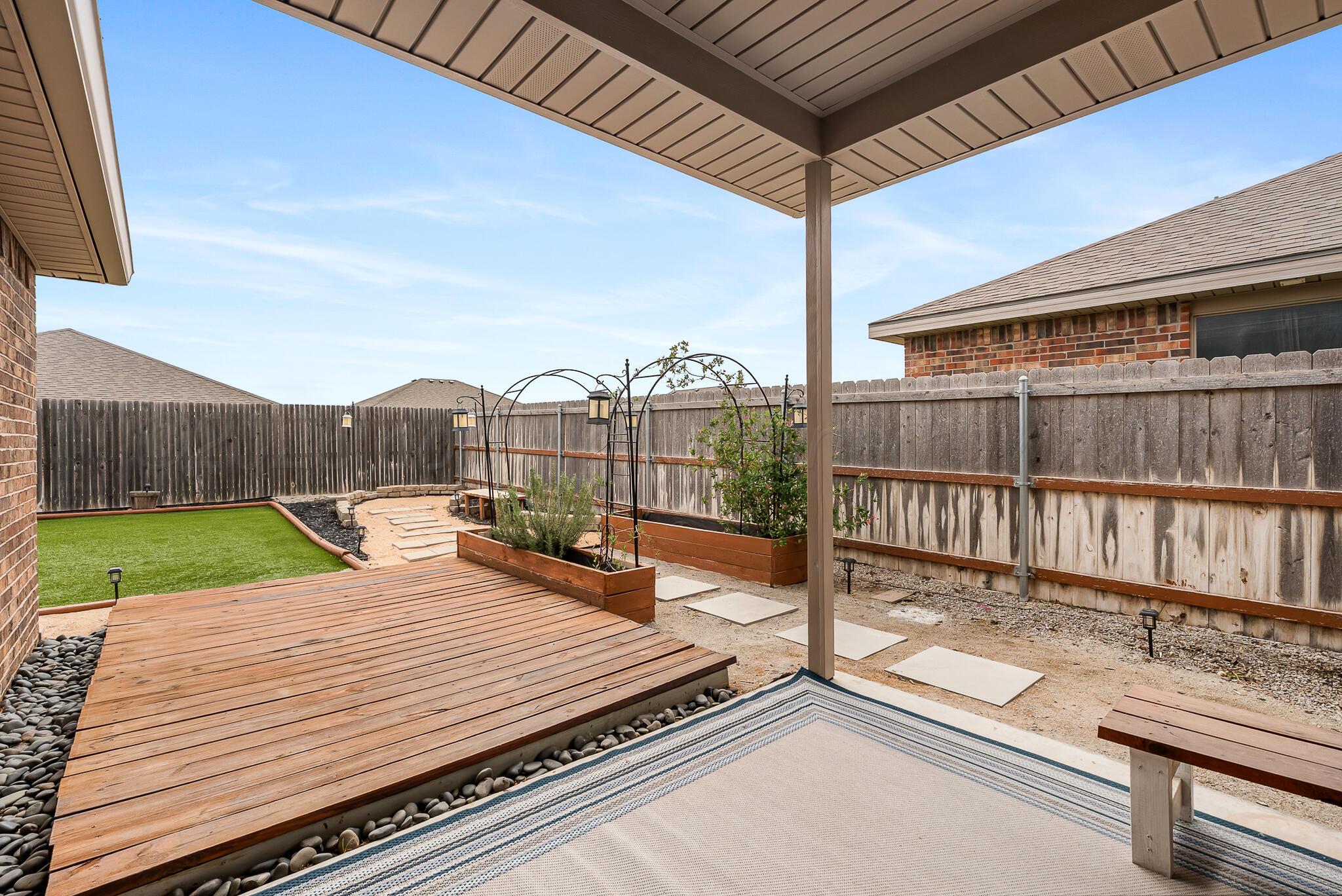 4807 Eberly Street Amarillo, TX 79118 - Photo 8 of 25 a view of a roof deck with wooden fence and a bench