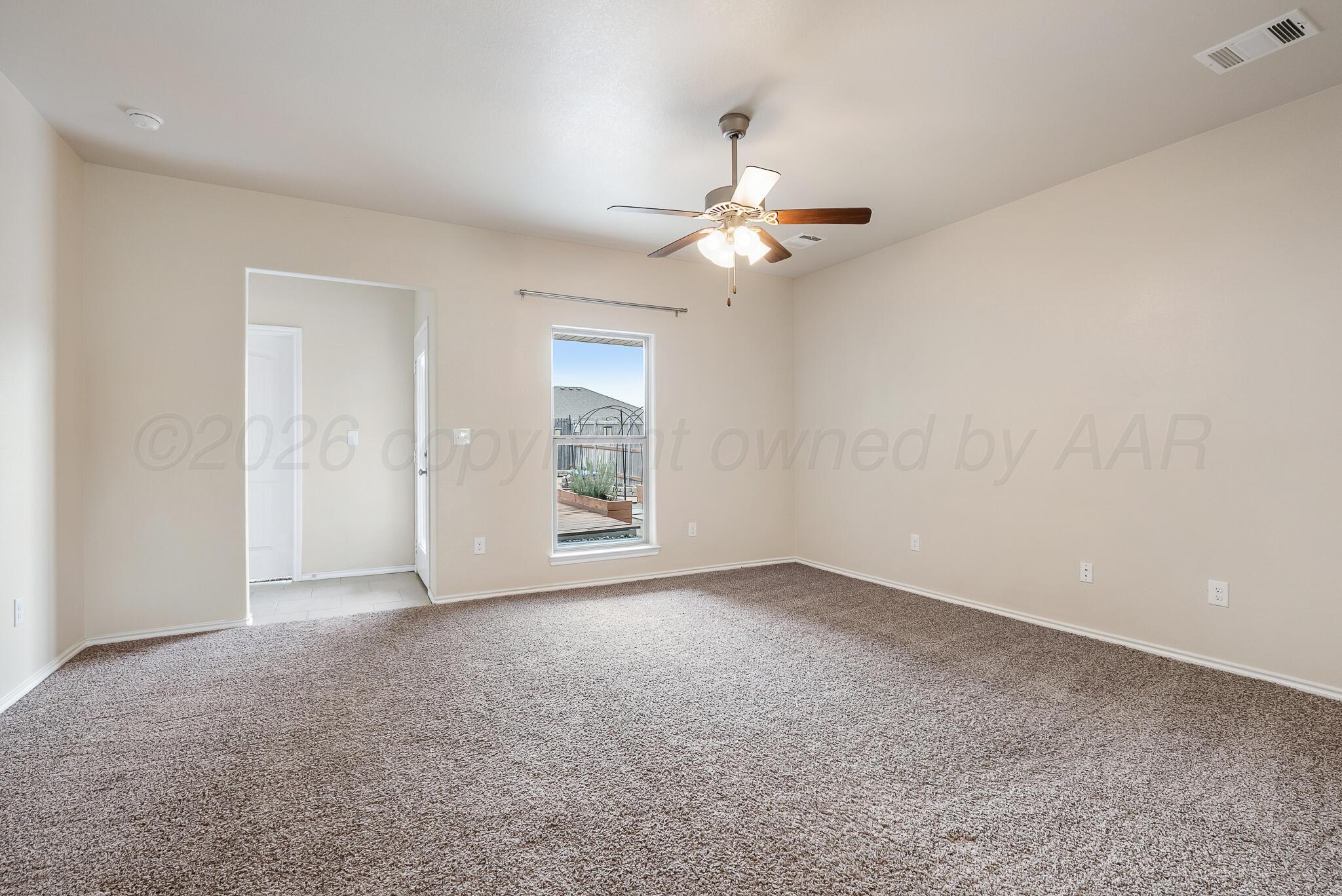 4807 Eberly Street Amarillo, TX 79118 - Photo 9 of 25 an empty room with windows and fan