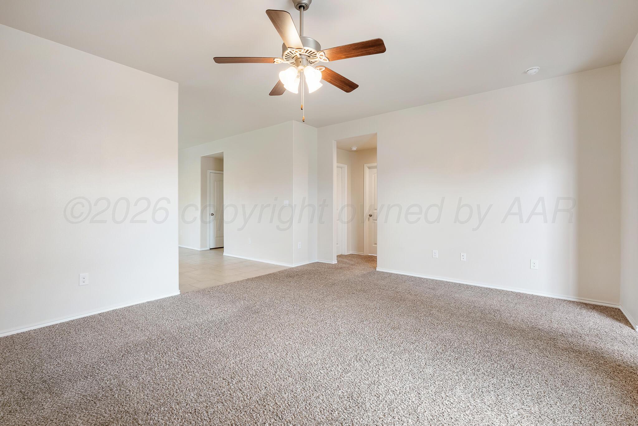 4807 Eberly Street Amarillo, TX 79118 - Photo 10 of 25 an empty room with ceiling fan and window