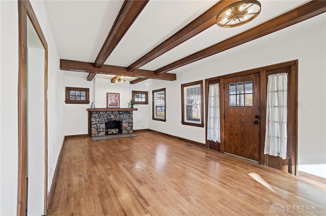 25 Englewood Road Springfield, OH 45504 - Photo 6 of 66 This inviting space features exposed beams and a rustic stone fireplace.