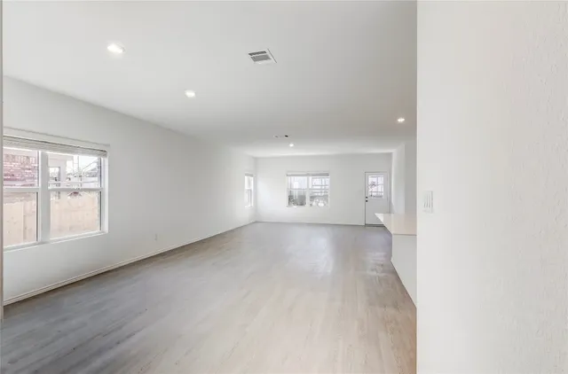 an empty room with windows and entrance