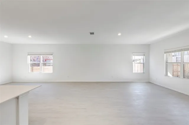 a view of a kitchen with a sink and a refrigerator
