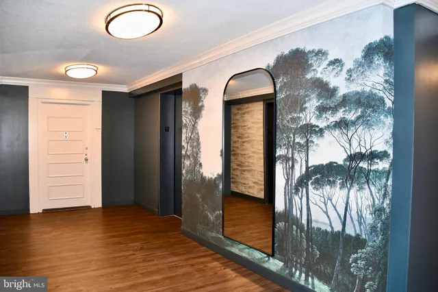 a view of empty room with wooden floor