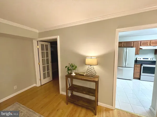 a kitchen with stainless steel appliances granite countertop a refrigerator a sink and dishwasher a stove with wooden cabinets