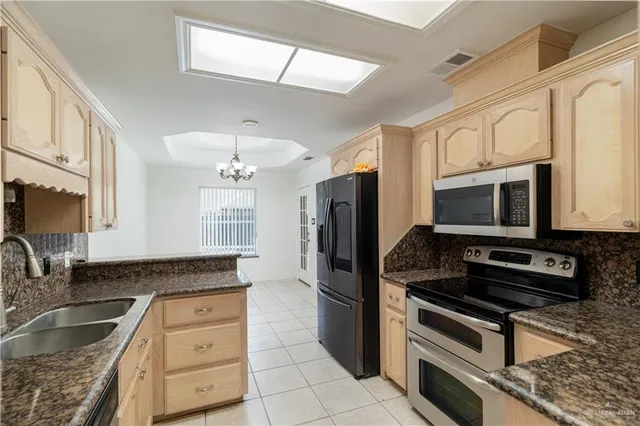 an empty room with wooden floor fan and window