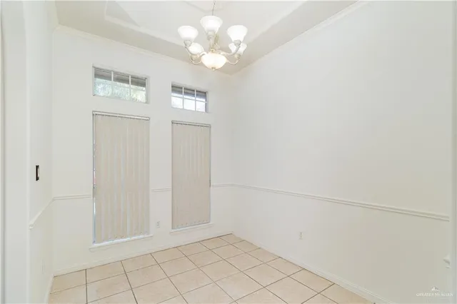 an empty room with closet and windows