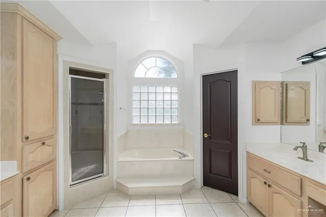 a en suite bathroom with a sink a mirror and a shower
