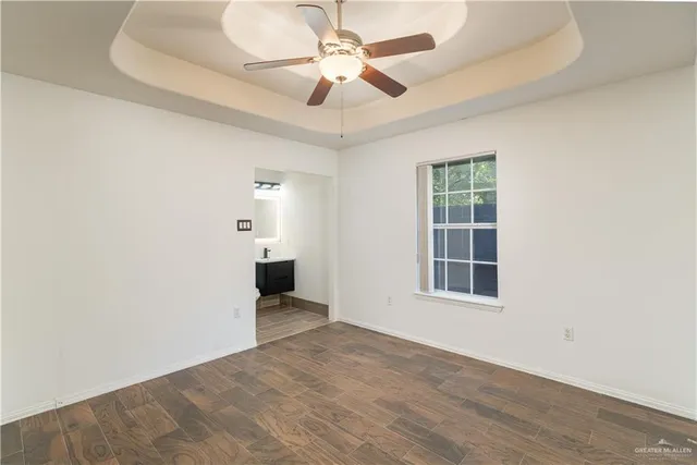 a bathroom with a sink vanity mirror and toilet