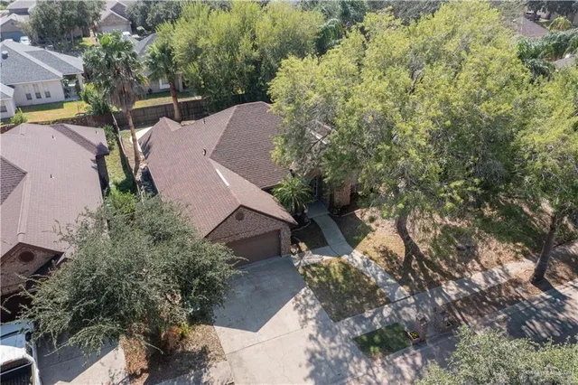 an aerial view of a house with a yard