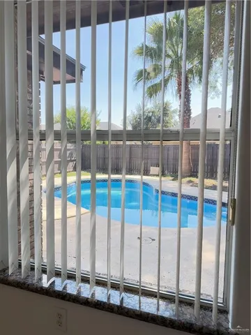 a kitchen with stainless steel appliances granite countertop a refrigerator a stove and a sink with wooden floors