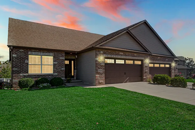 a front view of a house with a yard and garage