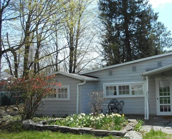 a front view of a house with a yard and a garden
