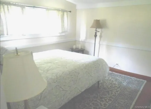 a bed sitting in a bathroom next to a window