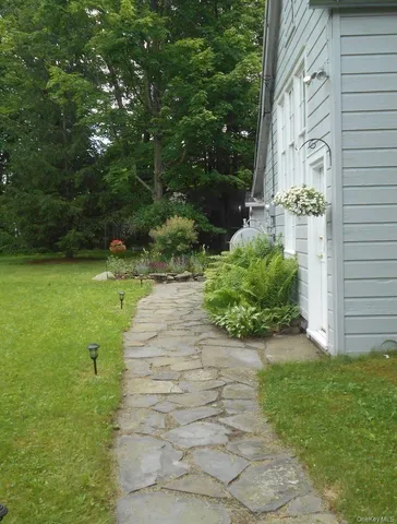 a view of a pathway with a yard