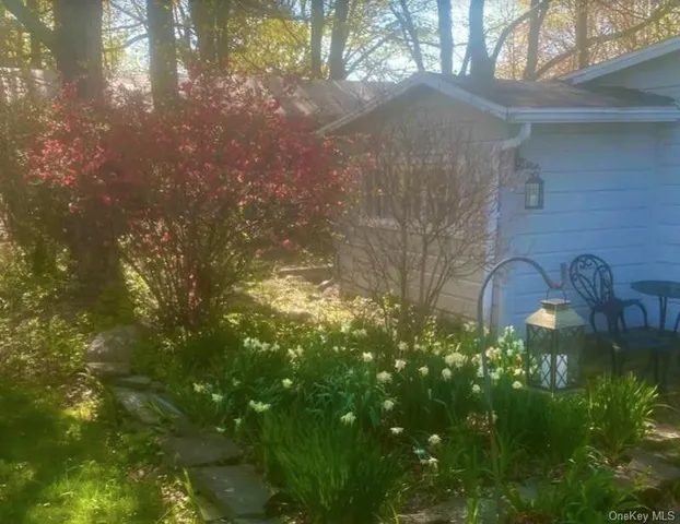 a backyard of a house with lots of green space and garden view