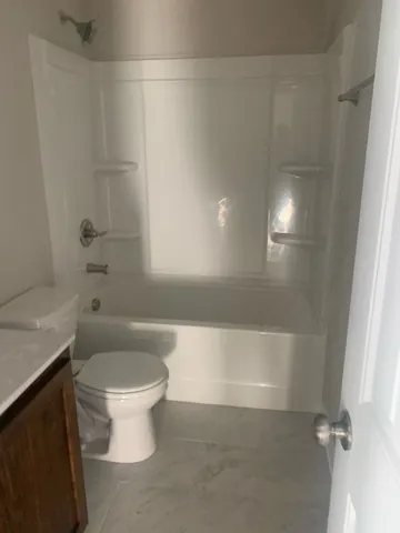 a bathroom with a bathtub and toilet