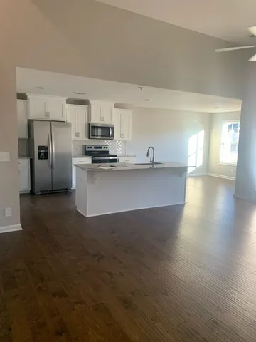 a kitchen with stainless steel appliances a sink stove and refrigerator