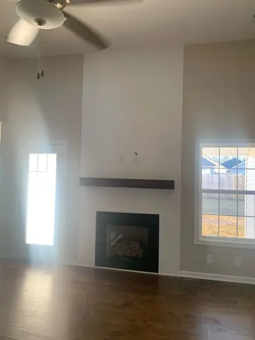 a living room with a fireplace and a floor to ceiling window