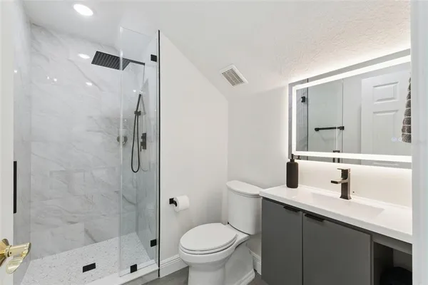 a kitchen with stainless steel appliances a stove a sink a refrigerator and cabinets