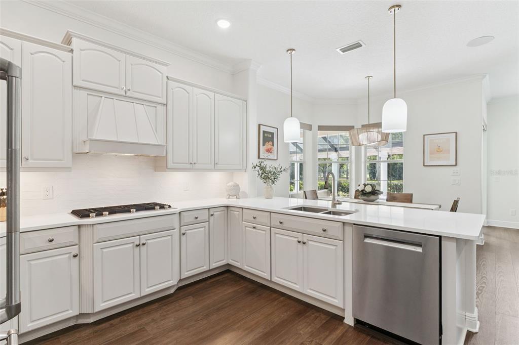 6110 Keenes Pointe Drive Windermere, FL 34786 - Photo 27 of 78 a kitchen with kitchen island white cabinets and white appliances