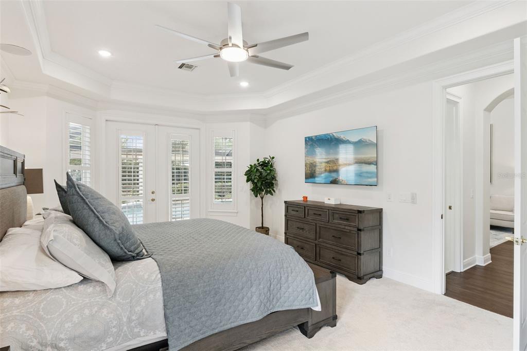 6110 Keenes Pointe Drive Windermere, FL 34786 - Photo 35 of 78 a bedroom with a bed a chandelier and dresser