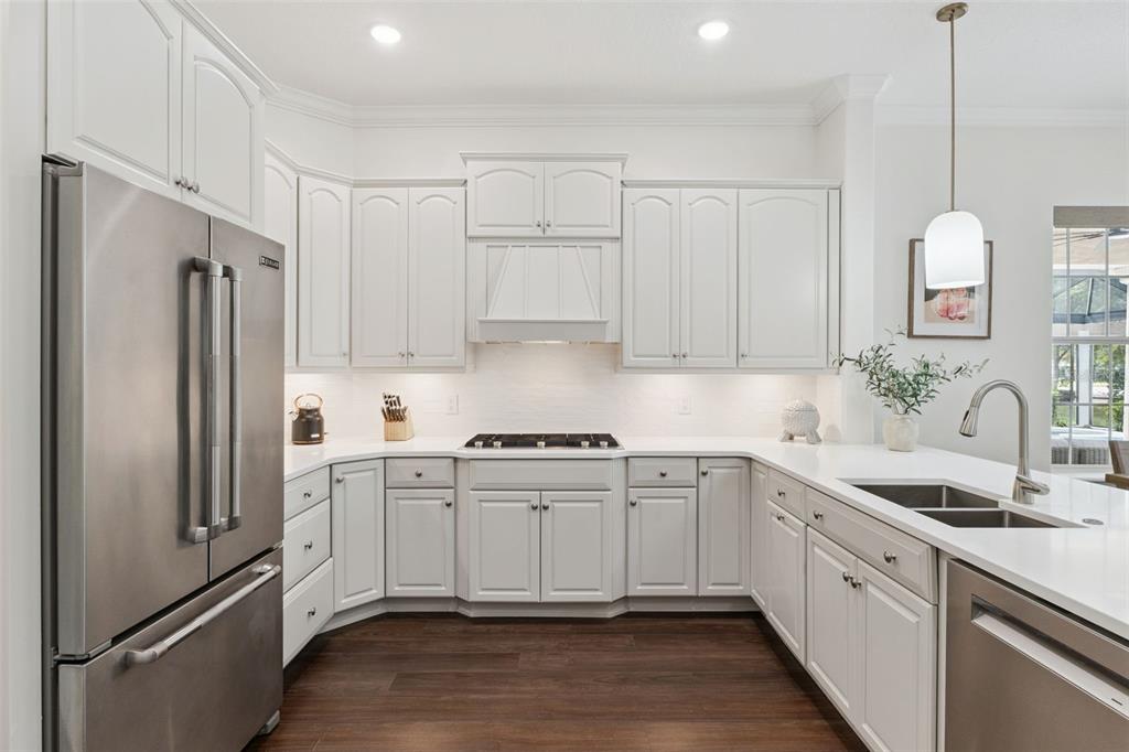 6110 Keenes Pointe Drive Windermere, FL 34786 - Photo 4 of 78 a kitchen with white cabinets white stainless steel appliances and sink