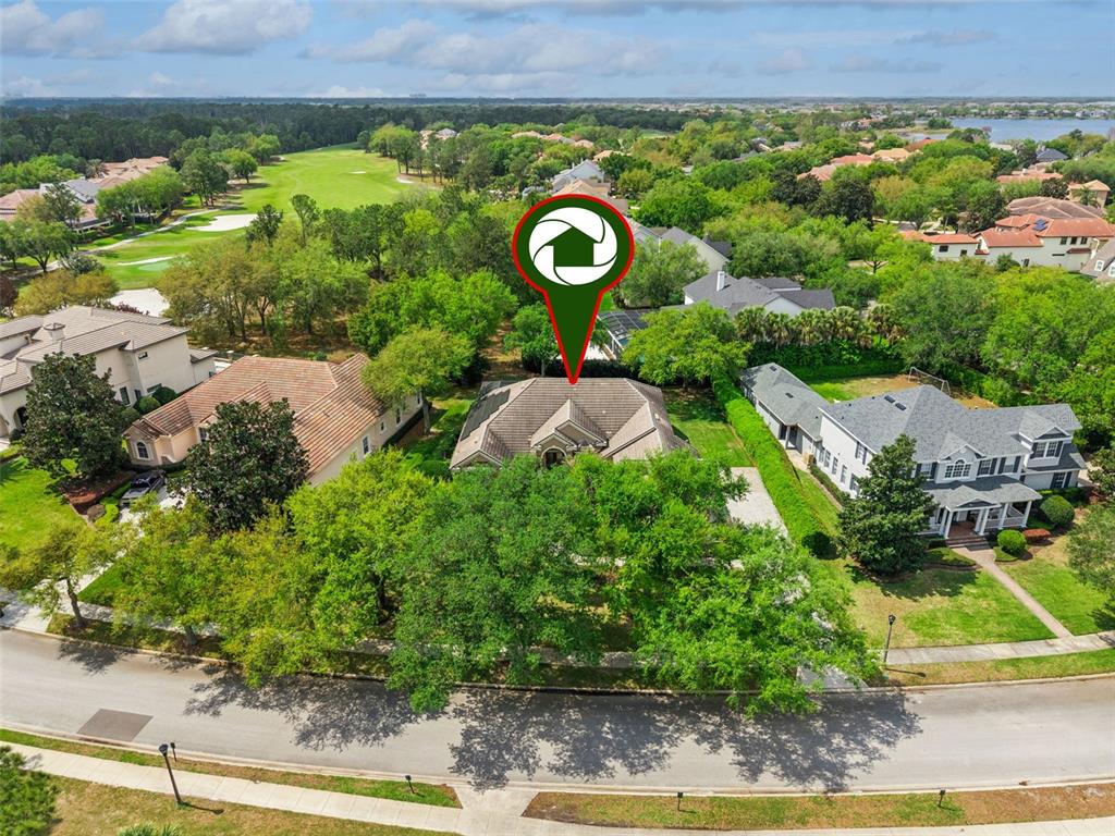 6110 Keenes Pointe Drive Windermere, FL 34786 - Photo 57 of 78 an aerial view of a house with garden space and street view