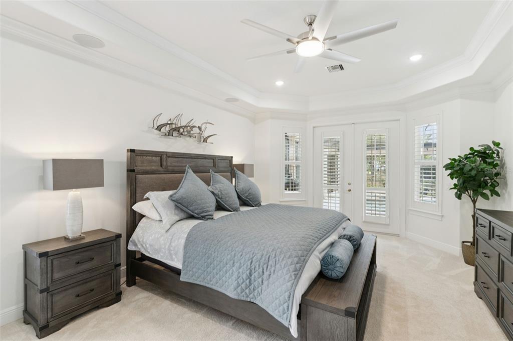6110 Keenes Pointe Drive Windermere, FL 34786 - Photo 9 of 78 a bedroom with a large bed and a chandelier