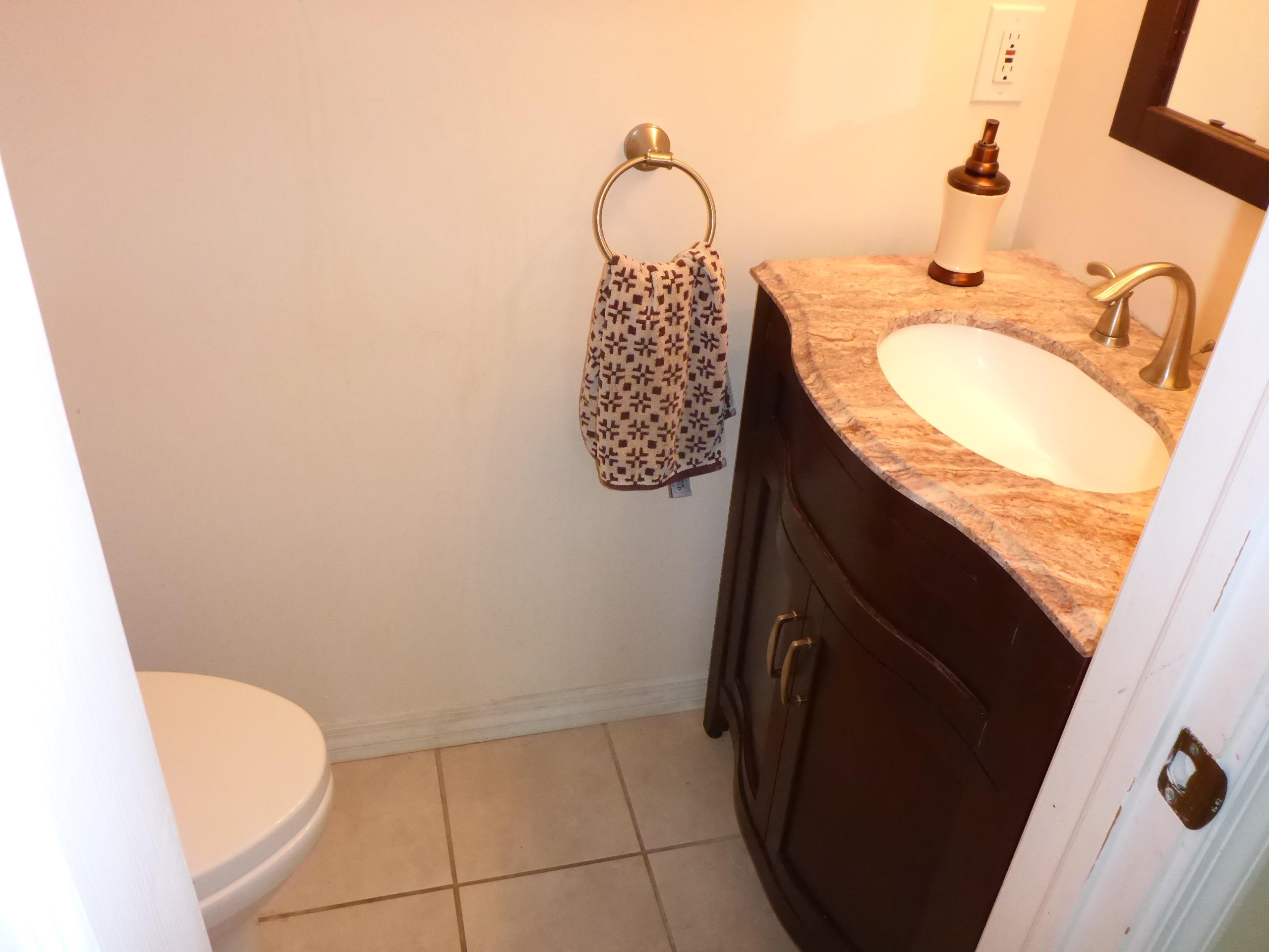 5124 Elpine Way Riviera Beach, FL 33418 - Photo 11 of 45 a bathroom with a granite countertop sink and a mirror