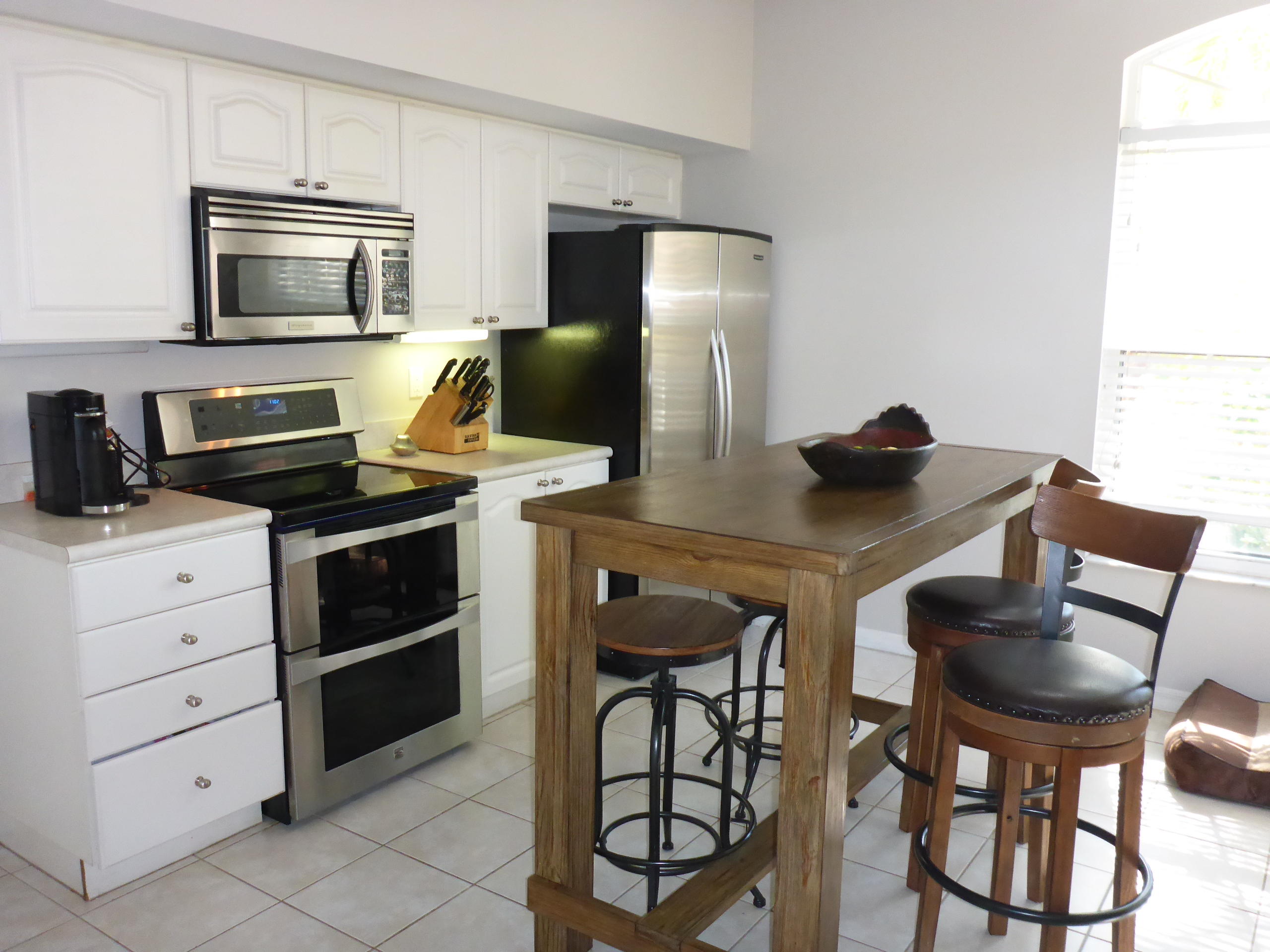 5124 Elpine Way Riviera Beach, FL 33418 - Photo 14 of 45 a kitchen with appliances cabinets and furniture