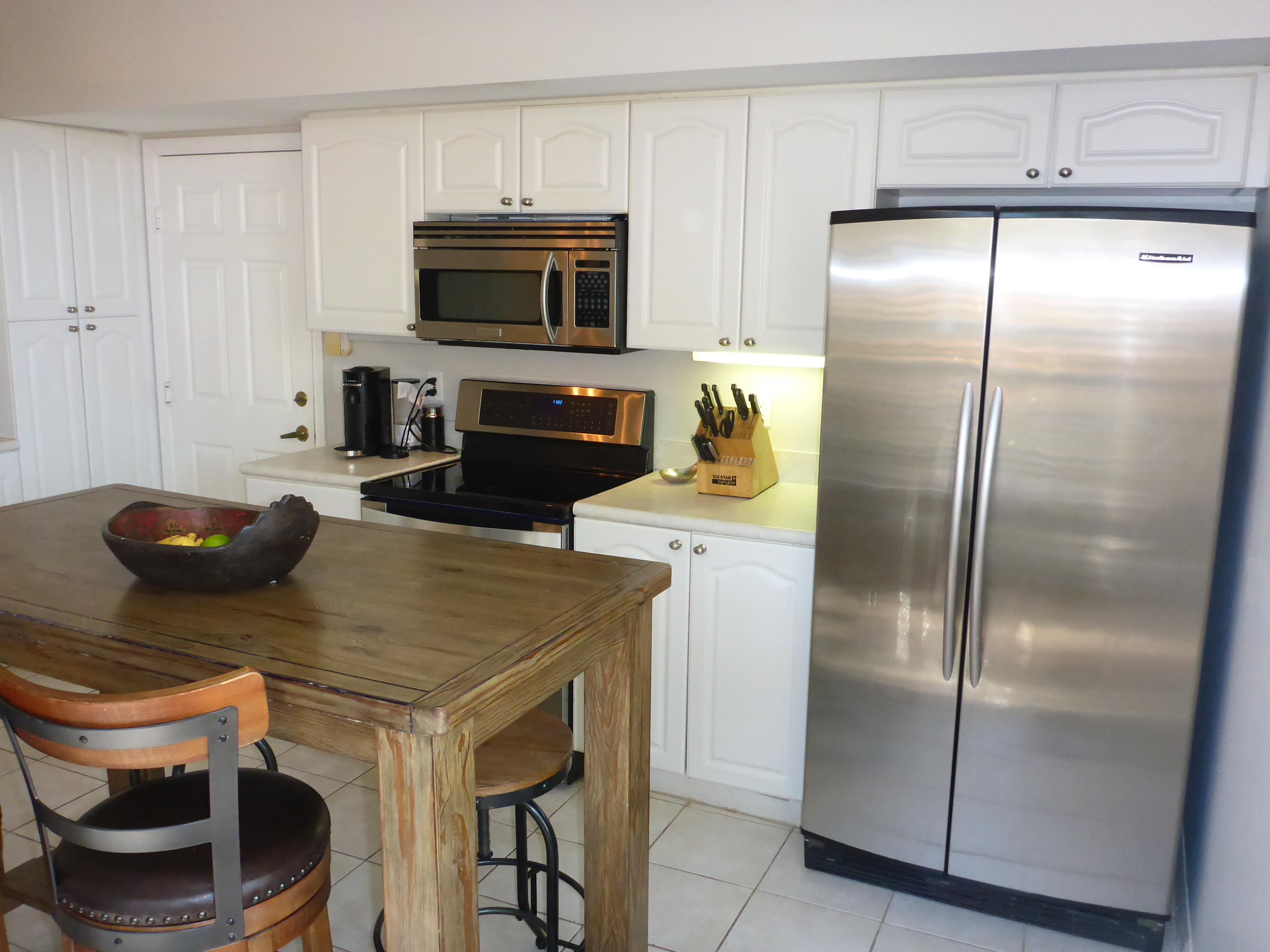 5124 Elpine Way Riviera Beach, FL 33418 - Photo 16 of 45 a kitchen with a appliances a refrigerator and cabinets