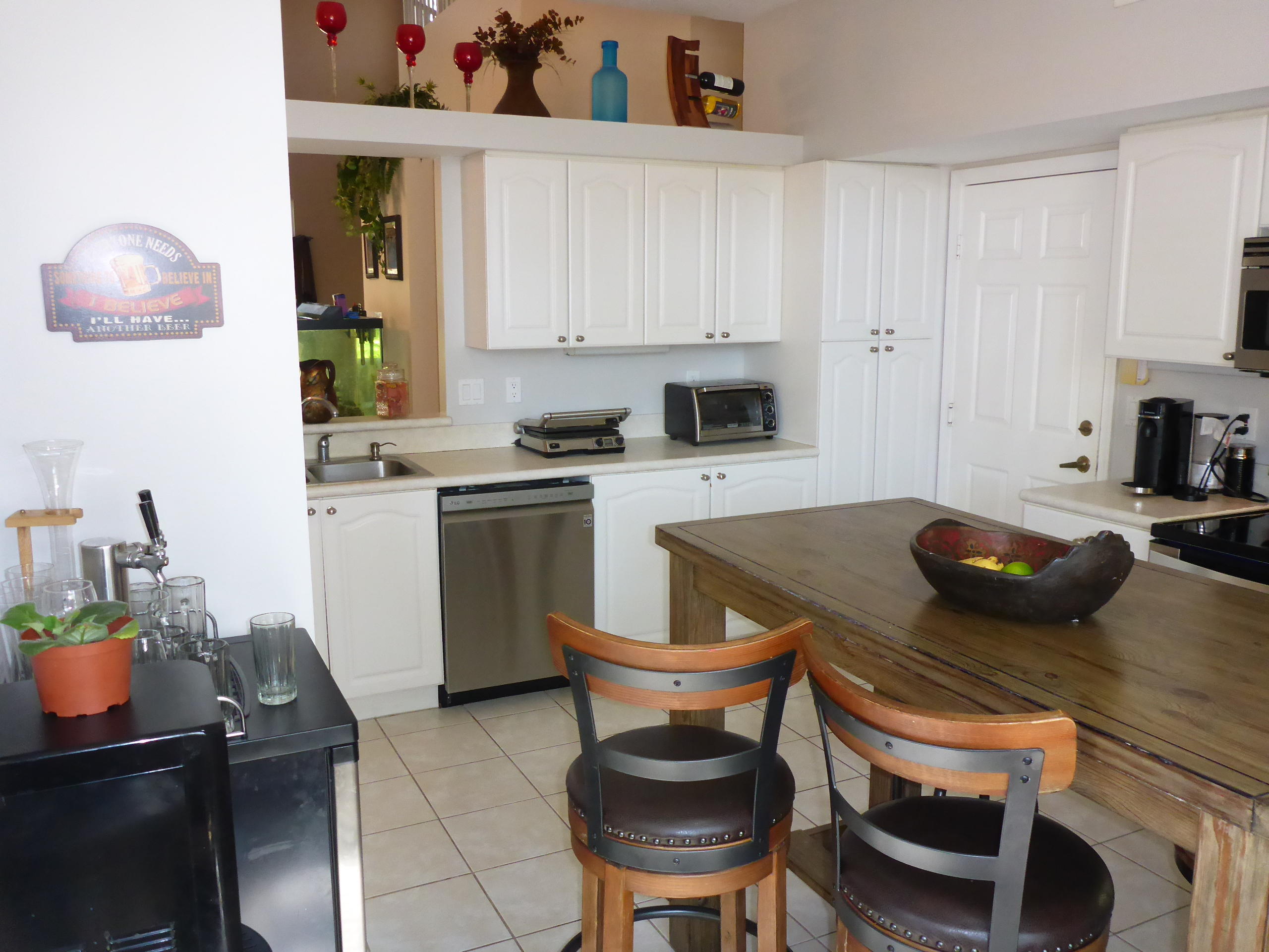 5124 Elpine Way Riviera Beach, FL 33418 - Photo 17 of 45 a kitchen with a stove a table and chairs