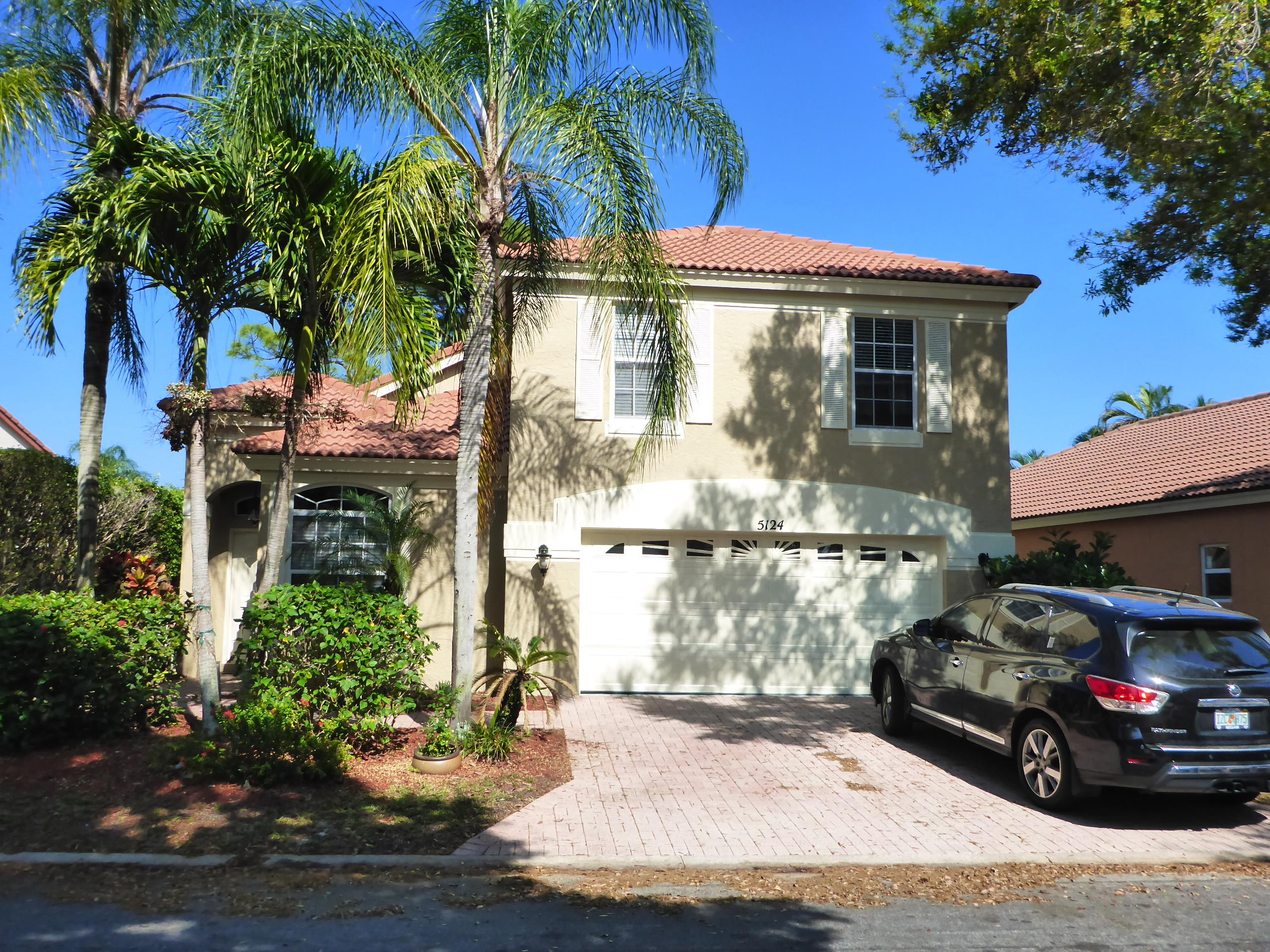 5124 Elpine Way Riviera Beach, FL 33418 - Photo 2 of 45 a front view of a house with garden