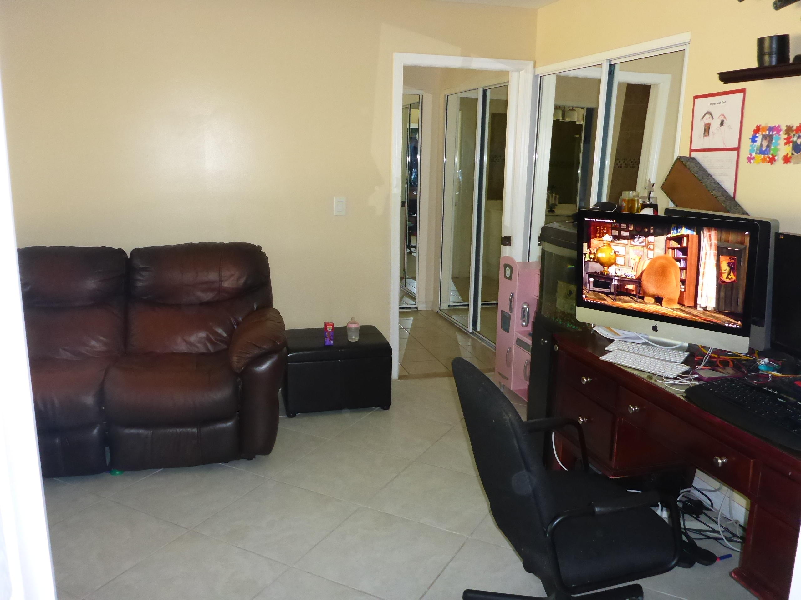 5124 Elpine Way Riviera Beach, FL 33418 - Photo 21 of 45 a living room with furniture and a flat screen tv