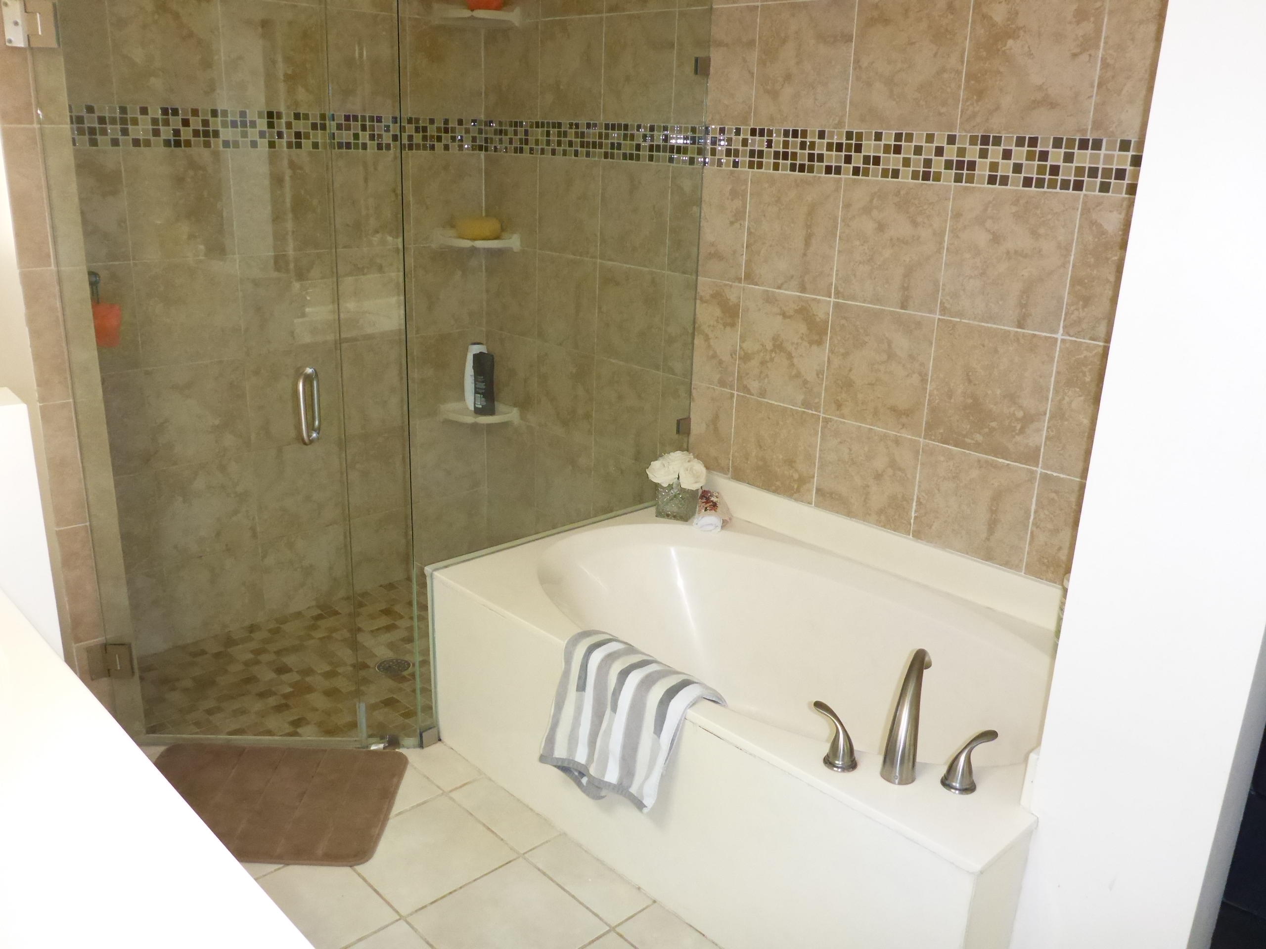5124 Elpine Way Riviera Beach, FL 33418 - Photo 26 of 45 a bathroom with a bathtub and a shower