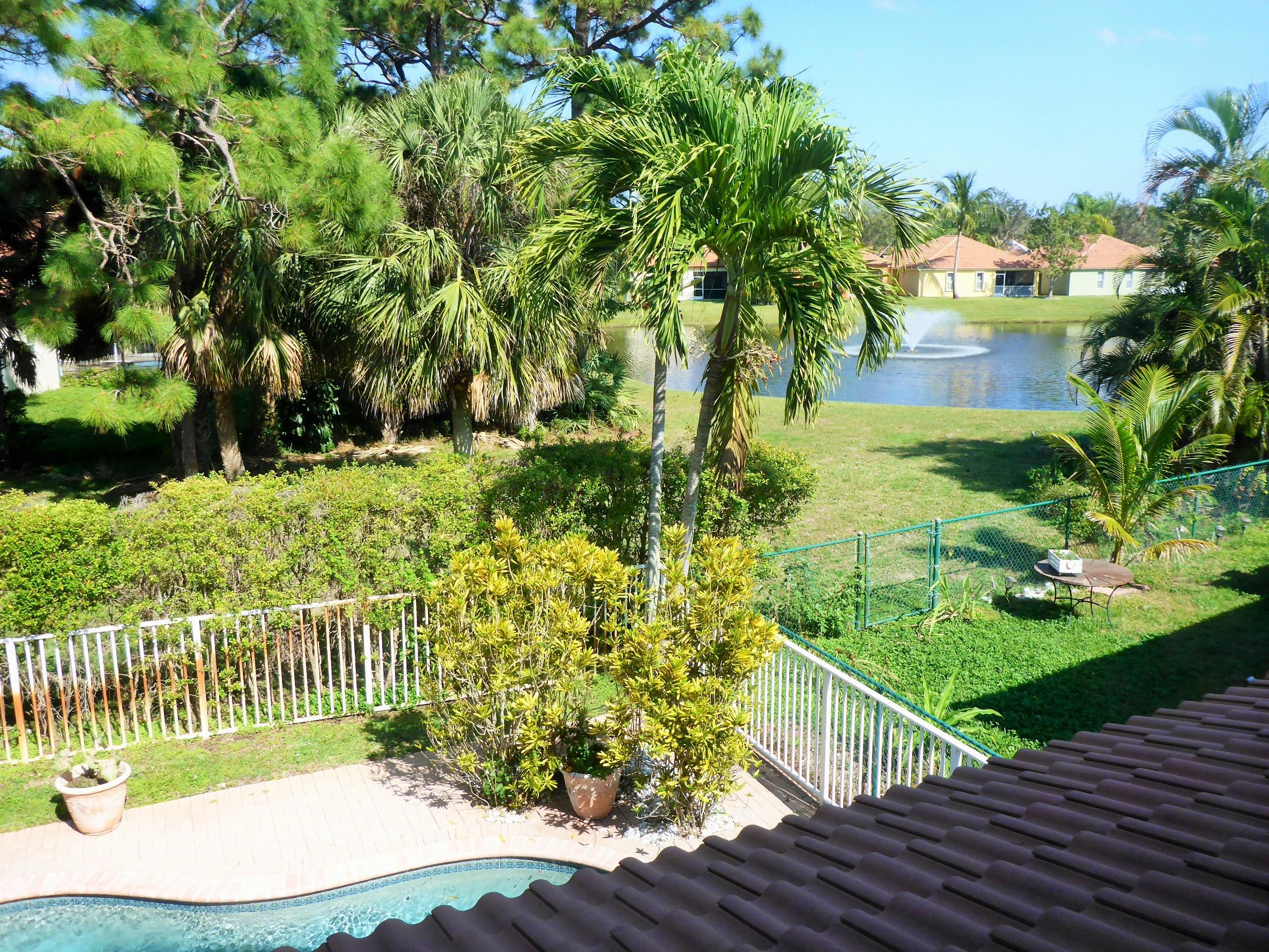 5124 Elpine Way Riviera Beach, FL 33418 - Photo 30 of 45 a balcony with trees in front of it