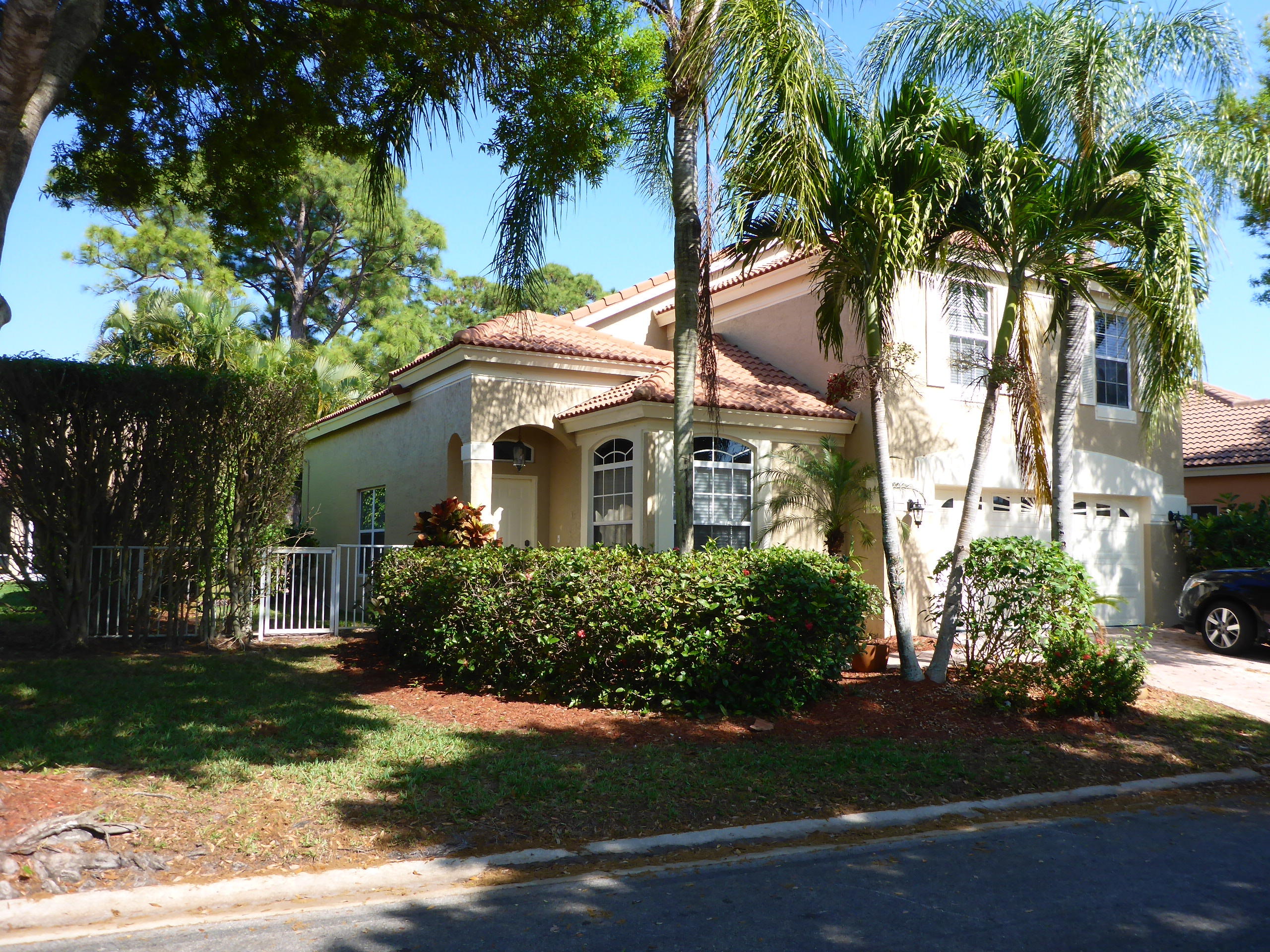 5124 Elpine Way Riviera Beach, FL 33418 - Photo 3 of 45 a front view of a house with a garden