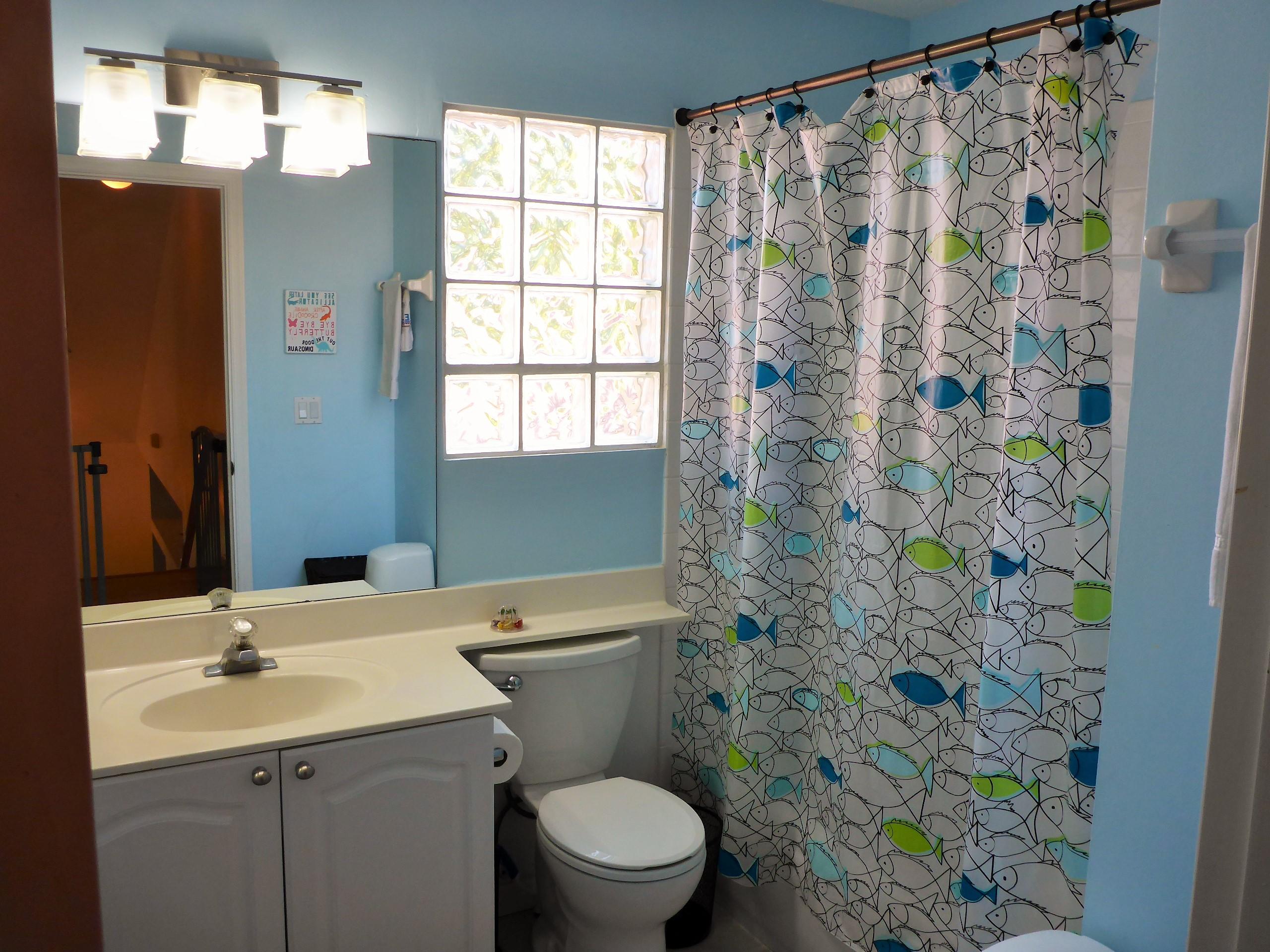 5124 Elpine Way Riviera Beach, FL 33418 - Photo 34 of 45 a bathroom with a sink and mirror with toilet